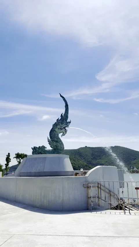 The Great Naga serpent statue spitting water into the sea under a bright bl.. Stock Footage 332792070