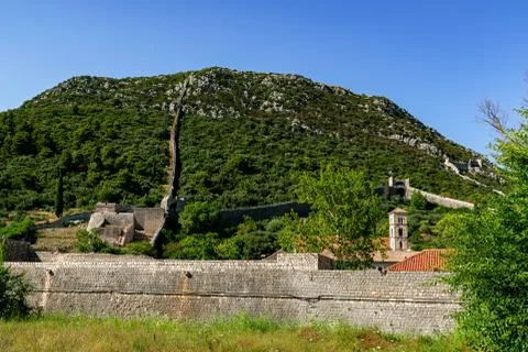 The great old wall of Ston with an old church tower Stock Photos