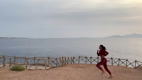 Great physical activity. Active young woman enjoying the view while jogging Stock Footage 151609788