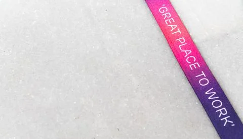 Great Place to Work - printed on a multicolored ribbon with off white background Stock Photos