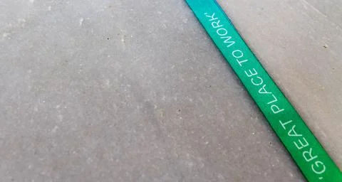 Great Place to Work - printed on a multicolored ribbon with off white background Stock Photos