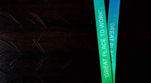 Great Place to Work - printed on a multicolored ribbon with off white background Stock Photos