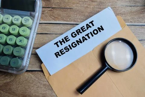 The great resignation text on document above brown envelope. Stock Photos