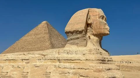 The Great Sphinx guards the pyramids of the pharaohs at Giza. Stock Photos