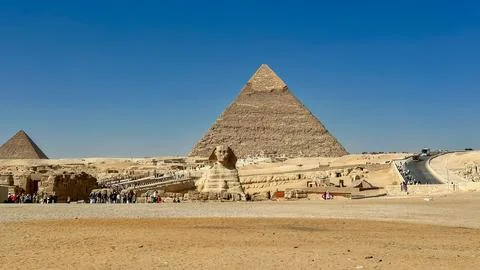 The Great Sphinx guards the pyramids of the pharaohs at Giza. Stock Photos