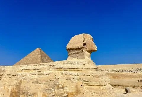The Great Sphinx guards the pyramids of the pharaohs at Giza. Stock Photos