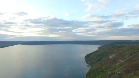 Great sunset on the lake between the mountains. A couple hugging at the edge of Stock Footage 87643926