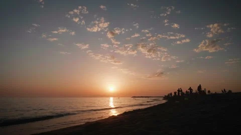 Great sunset, reflection of sun on water. Wide angle and silhuette people Stock Footage 137694466
