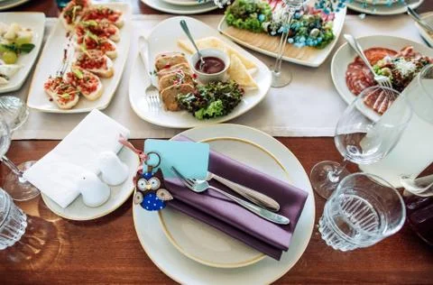 Great table set in the restaurant for a festive dinner. White tablecloth, whi Stock Photos
