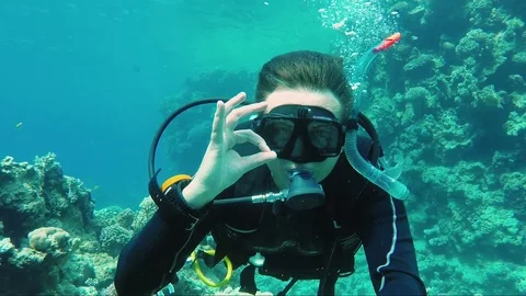 Great vacation and diving in the warm sea. The scuba diver signs the okay sign Stock Footage 74142931
