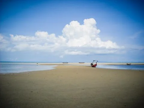 Great view over the sandy beach. Beautiful clouds in the blue sky. Islands .. Stock Photos
