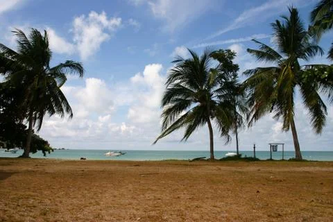 Great view over the sandy beach. Beautiful clouds in the blue sky. Islands .. Stock Photos
