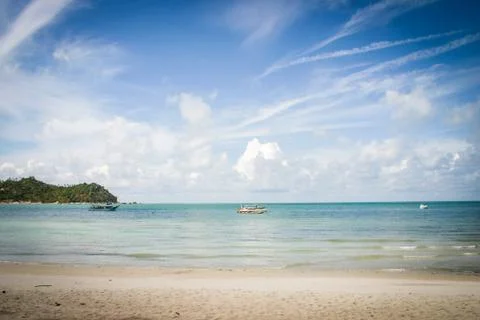 Great view over the sandy beach. Beautiful clouds in the blue sky. Islands .. Stock Photos
