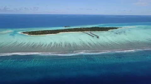Great view from sky to Island in the middle of ocean with waves and blue lagoon Stock Footage 120680888