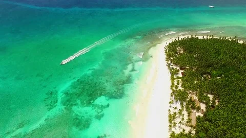 Great view on the white beach huge forest and a motor boat in the ocean Stock Footage 71788172