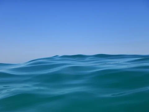 Great wave on the blue open sea with blue sky only in background Stock Photos