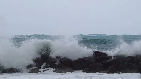 Great waves over wavebreaker half speed motion Stock Footage 190588808