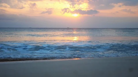Great waves of a powerful ocean break into foam during beautiful sunset on the Stock Footage 92780117