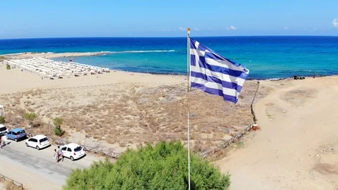 Greece flag blowing in sea breeze, Crete Stock Footage 100708180