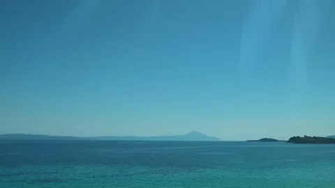 Greece flag flaps in wind against clear sky. Trani Ammouda, Greece 스톡 동영상 339614884