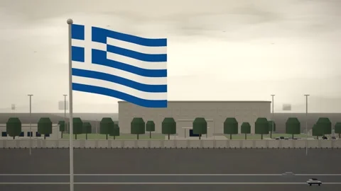 Greece Flag Flying Over Embassy Compound Perimeter Wall seamless loop Stock Footage 345131593