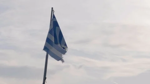 A Greece flag in a not so good condition, waving in the wind. The flag was Stock Footage 119962213