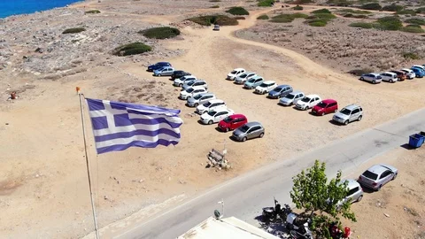 Greece flag waving on wind, aerial Crete coast panorama Stock Footage 100757308