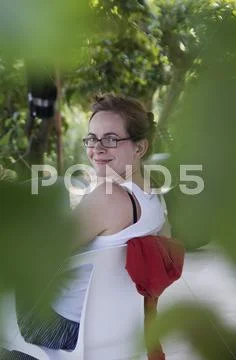 Greece, Ionian Islands, Ithaca, Mid adult woman sitting on chair, smiling Stock Photos
