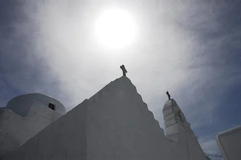 Greece- Mykonos- Close Up of Bright Sun Behind Crosses on Church Roof Stock Photos