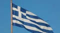 Greece national flag waving on flagpole on blue sky background HD Footage