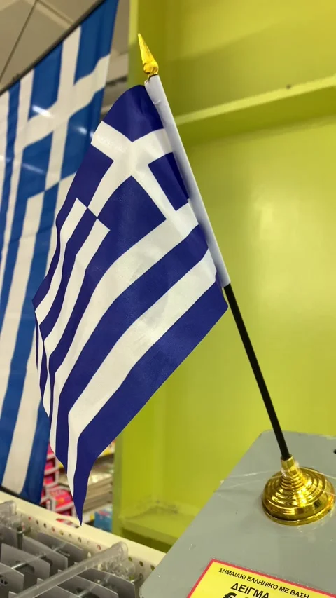 Greece small flag fluttering on a flagpole. In supermarket for holiday. HD Vídeo Stock 218112661