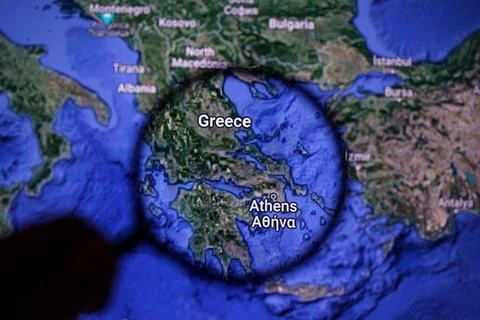 Greece on wildfire. Greece on maps through magnifying glass Stock Photos