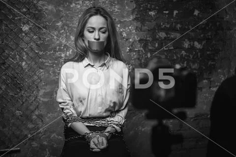 Greedy mad criminal filming a video for ransom Stock Photos