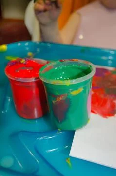 Greee and red paint cans for kids Stock Photos