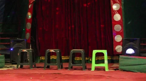 Greeen chairs in front of red curtains in the circus arena Stock Footage 44453061