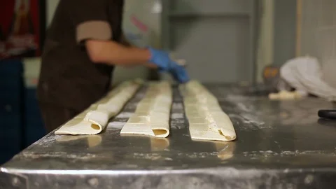 The Greek bakery, the chef makes the roll with a stuffing Stock Footage 106477448