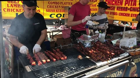 Greek Beef Kebabs Turned on Large Grill Stock Footage 76131510