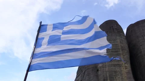 Greek Flag Blowing in the Wind Slow Motion Low Angle on a Hill in Meteora, .. Stock Footage 334897425