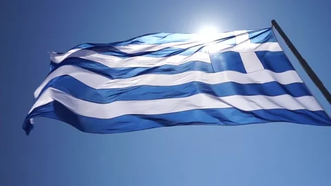 The Greek flag dances in the wind in slow motion, in beautiful Santorini, Greece Stock-Footage 131194643