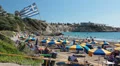 Greek flag at the entrance to the Coral Bay beach in Peyia, Paphos, Cyprus HD Footage