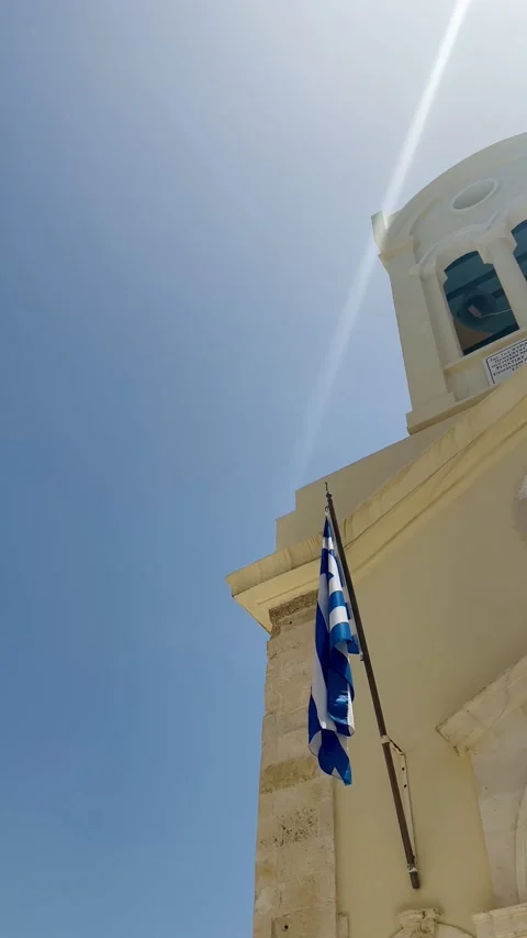 Greek flag fluttering in the wind over a medieval church Stock Footage 280041101