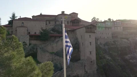 Greek Flag Waving Holy Monastery of Great Meteoron Meteora Sun Flare. Slow .. Stock Footage 334871085