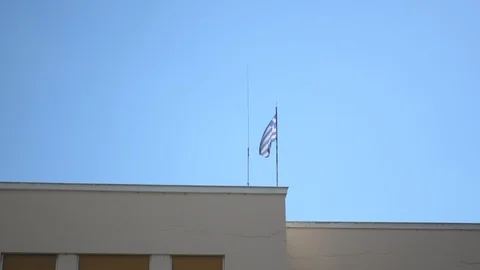 Greek flag waving on a rooftop Stock Footage 112742084