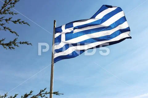 Greek flag waving on a sunny but windy day on the island of Rhodes Stock Photos