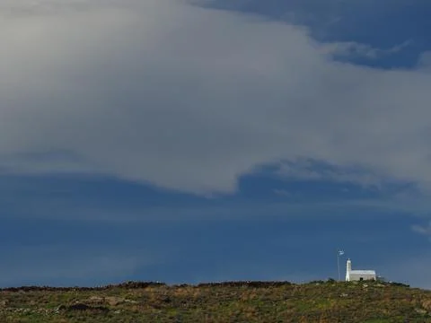 Greek Hilltop Chapel with Dramatic Cloudscape and Expansive Sky - Kea Island Stock Photos