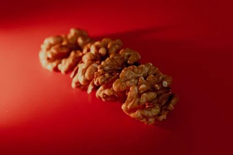 Greek nuts without shell on red background macro Stock Photos