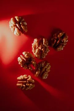 Greek nuts without shell on red background macro Stock Photos