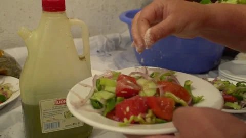Greek salad adding salt and olive oil Stock Footage 144489627