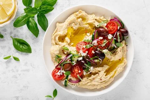 Greek style vegan mediterranean hummus with fresh vegetables, olives Stock Photos