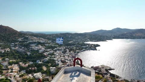 Greek Torn flag on a pole fluttering in the wind on the roof of an church Stock Footage 247077196